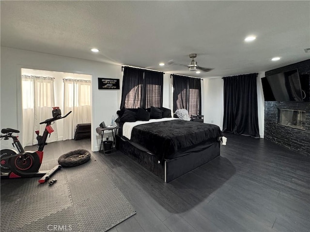 9135 Cord Ave, Downey, CA 90240 - bedroom with a glass covered fireplace, recessed lighting, dark wood-style flooring, and a ceiling fan