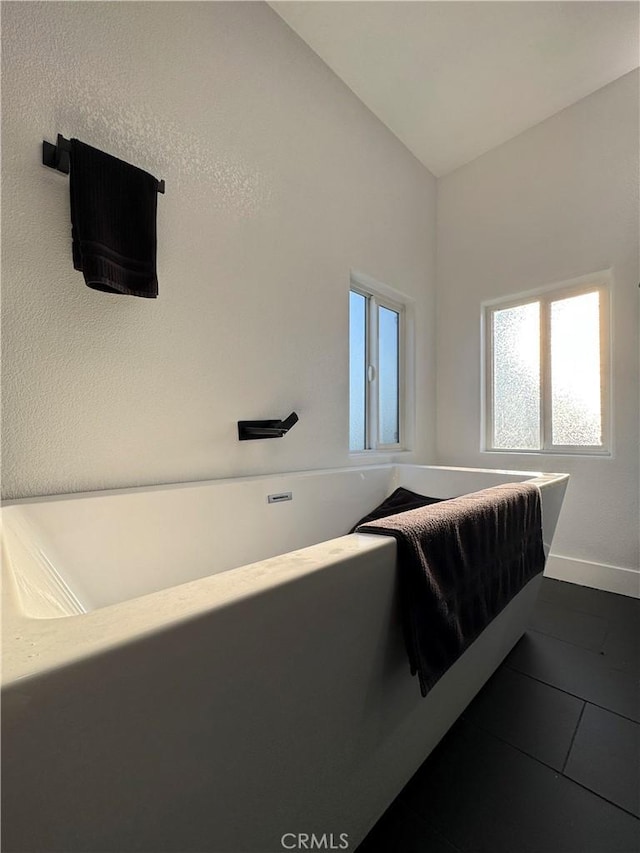 9135 Cord Ave, Downey, CA 90240 - unfurnished bedroom with multiple windows and dark tile patterned flooring