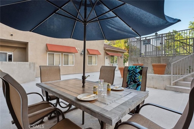 9610 Zelzah Ave Unit 105, Northridge, CA 91325 - view of patio featuring outdoor dining space and stairs