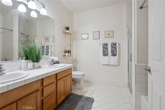 9610 Zelzah Ave Unit 105, Northridge, CA 91325 - full bathroom featuring a shower stall, double vanity, and tile patterned floors