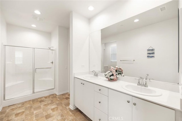31268 Via Nubes, Temecula, CA 92592 - bathroom with double vanity, a stall shower, recessed lighting, and stone finish flooring