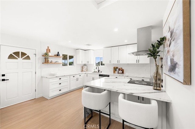 8252 Graves Ave, Rosemead, CA 91770 - kitchen with island range hood, a peninsula, decorative backsplash, a breakfast bar area, and recessed lighting