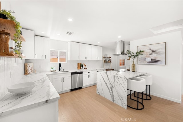 8252 Graves Ave, Rosemead, CA 91770 - kitchen featuring wall chimney exhaust hood, stainless steel dishwasher, tasteful backsplash, light wood-style floors, and light stone counters