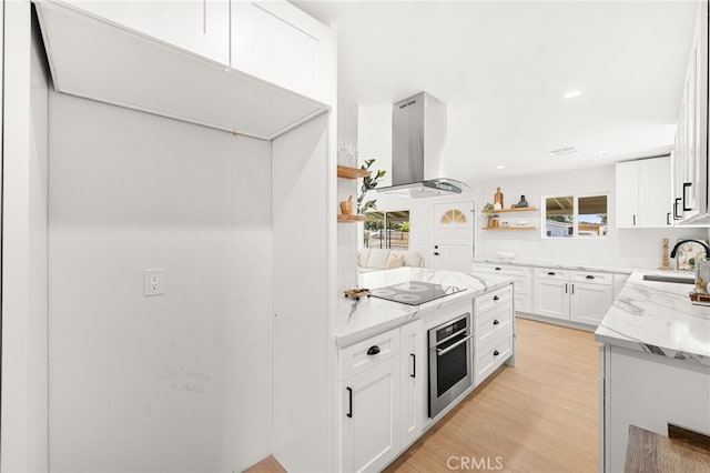 8252 Graves Ave, Rosemead, CA 91770 - kitchen with island range hood, stainless steel oven, black electric cooktop, open shelves, and light wood-style flooring