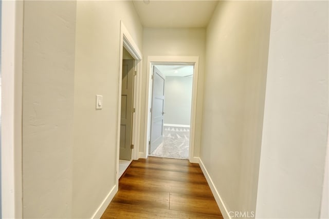 25904 Bear Valley Rd, Tehachapi, CA 93561 - hall with dark wood-style flooring and baseboards