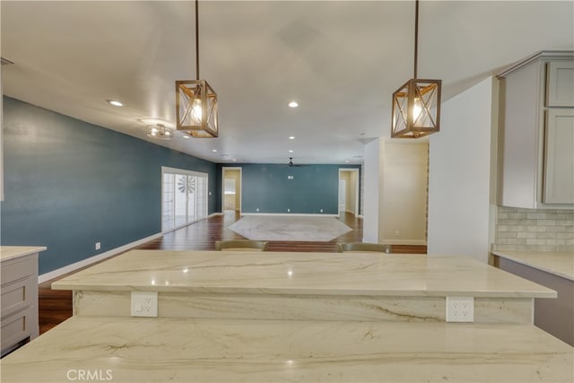 25904 Bear Valley Rd, Tehachapi, CA 93561 - kitchen featuring light stone countertops, gray cabinetry, recessed lighting, and decorative light fixtures
