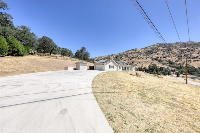 25904 Bear Valley Rd, Tehachapi, CA 93561 - ranch-style house featuring concrete driveway, an attached garage, and a mountain view
