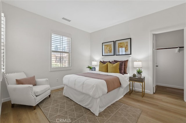 26 Los Indios, Irvine, CA 92618 - bedroom with light wood-type flooring and a spacious closet