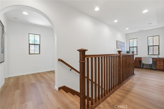 26 Los Indios, Irvine, CA 92618 - hall featuring an upstairs landing, light wood-style flooring, healthy amount of natural light, arched walkways, and recessed lighting