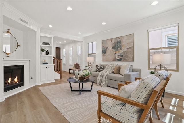 26 Los Indios, Irvine, CA 92618 - living room with light wood-style floors, recessed lighting, crown molding, stairway, and a glass covered fireplace