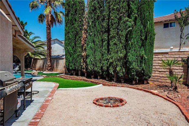 39423 Rowan Ct, Palmdale, CA 93551 - fenced backyard with a patio area and a fire pit