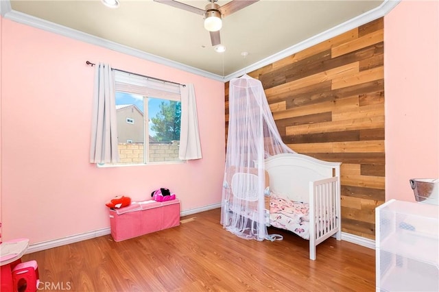 39423 Rowan Ct, Palmdale, CA 93551 - bedroom with wooden walls, ornamental molding, and wood finished floors