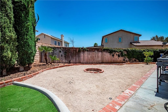 39423 Rowan Ct, Palmdale, CA 93551 - fenced backyard featuring a fire pit and a patio area