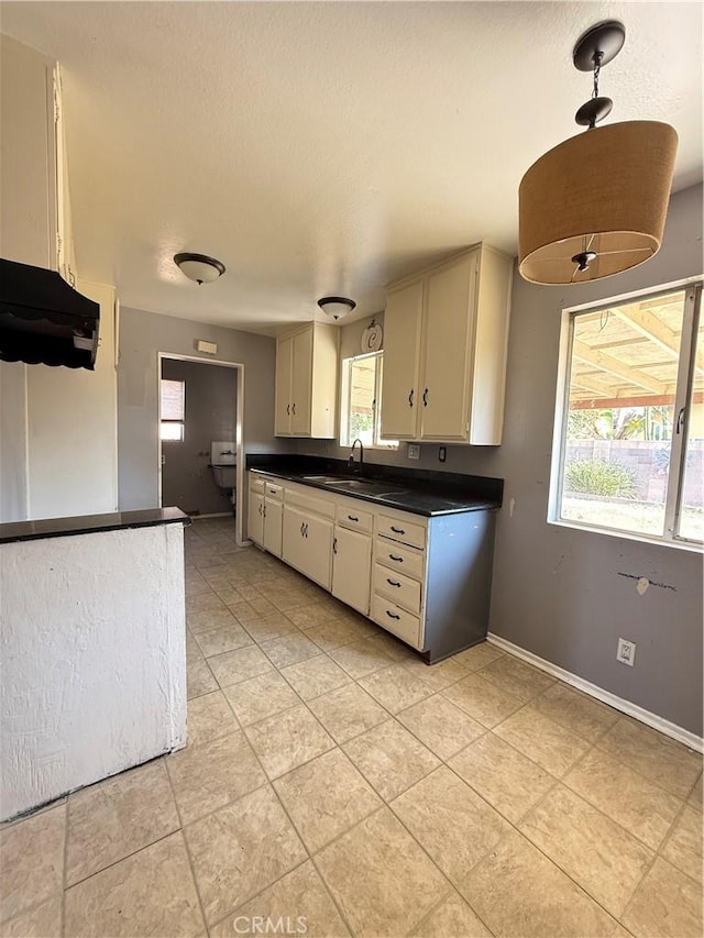 7560 El Escorial Way, Buena Park, CA 90620 - kitchen featuring dark countertops, light tile patterned flooring, and plenty of natural light