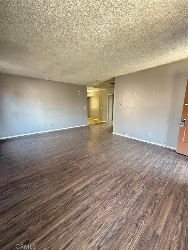 7560 El Escorial Way, Buena Park, CA 90620 - spare room featuring dark wood-style floors and a textured ceiling
