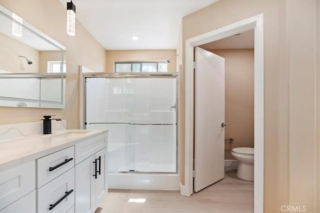 66101 14th St, Desert Hot Springs, CA 92240 - bathroom featuring a tile shower, double vanity, and wood finished floors