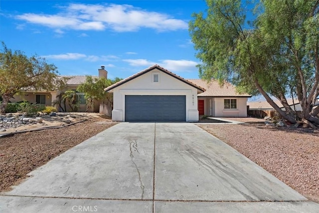 66101 14th St, Desert Hot Springs, CA 92240 - ranch-style house with concrete driveway, an attached garage, stucco siding, and a tiled roof