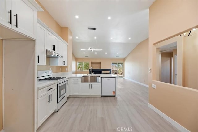 66101 14th St, Desert Hot Springs, CA 92240 - kitchen with white appliances, under cabinet range hood, open floor plan, white cabinets, and light wood-type flooring