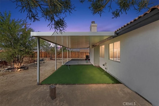 66101 14th St, Desert Hot Springs, CA 92240 - patio terrace at dusk featuring a fenced backyard and a patio area