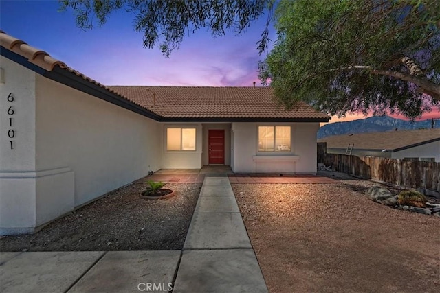 66101 14th St, Desert Hot Springs, CA 92240 - view of exterior entry featuring stucco siding and a tile roof