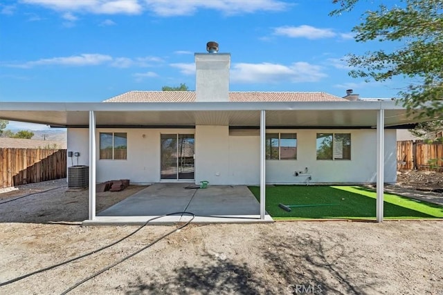 66101 14th St, Desert Hot Springs, CA 92240 - rear view of house with a chimney, a patio area, a tile roof, and stucco siding