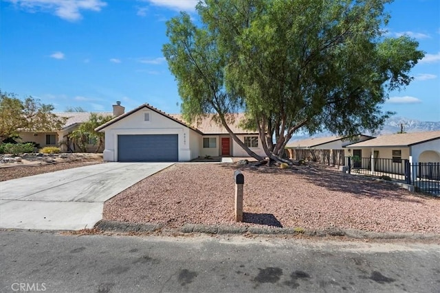 66101 14th St, Desert Hot Springs, CA 92240 - ranch-style house featuring a garage, driveway, stucco siding, and a chimney