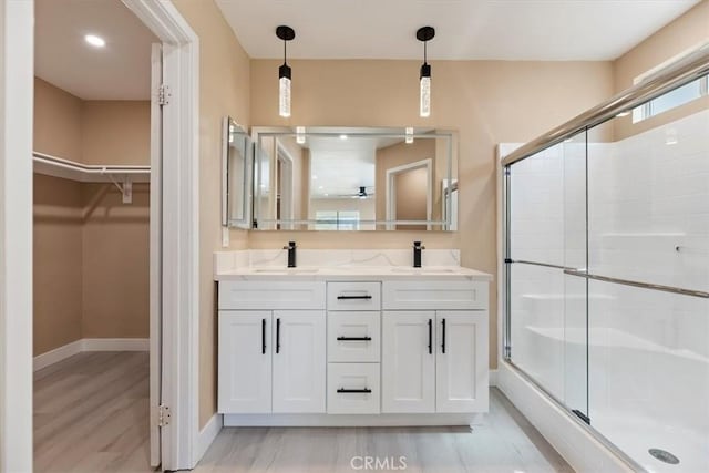 66101 14th St, Desert Hot Springs, CA 92240 - full bathroom featuring a shower stall, double vanity, wood finished floors, and a spacious closet