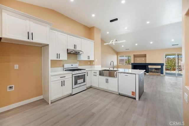 66101 14th St, Desert Hot Springs, CA 92240 - kitchen featuring white appliances, lofted ceiling, under cabinet range hood, light wood finished floors, and white cabinetry