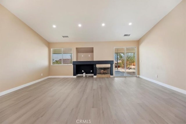 66101 14th St, Desert Hot Springs, CA 92240 - unfurnished living room featuring light wood-type flooring, a multi sided fireplace, and recessed lighting