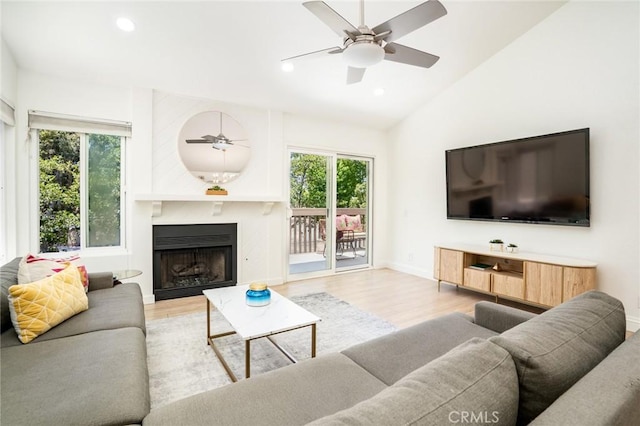 16521 Grunion Ln Unit 207, Huntington Beach, CA 92649 - living room with healthy amount of natural light, wood finished floors, recessed lighting, vaulted ceiling, and a ceiling fan