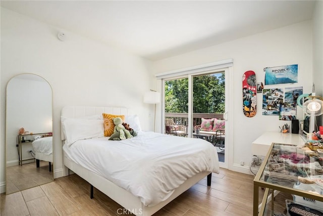 16521 Grunion Ln Unit 207, Huntington Beach, CA 92649 - bedroom featuring access to exterior and light wood-type flooring