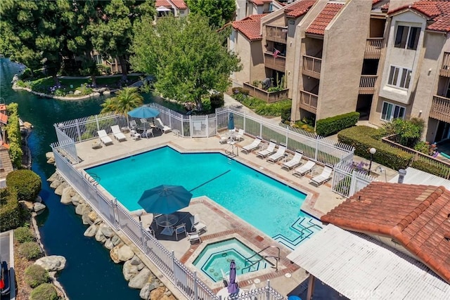16521 Grunion Ln Unit 207, Huntington Beach, CA 92649 - community pool featuring a community hot tub, a patio, and a water view