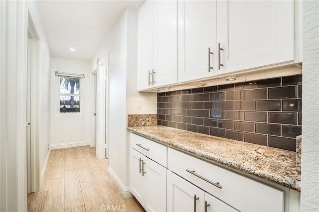 16521 Grunion Ln Unit 207, Huntington Beach, CA 92649 - kitchen with tasteful backsplash, white cabinets, light wood-style flooring, light stone counters, and recessed lighting