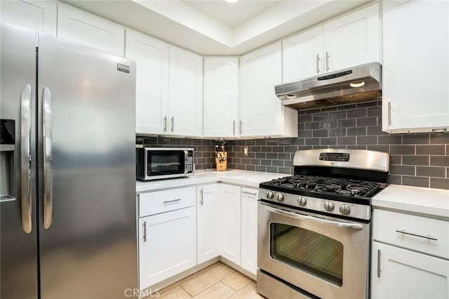 16521 Grunion Ln Unit 207, Huntington Beach, CA 92649 - kitchen with stainless steel appliances, under cabinet range hood, light countertops, decorative backsplash, and white cabinets