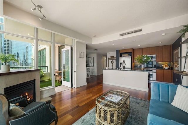 1199 Pacific Unit 1303, San Diego, CA 92101 - living room with dark wood-style flooring, a glass covered fireplace, and recessed lighting
