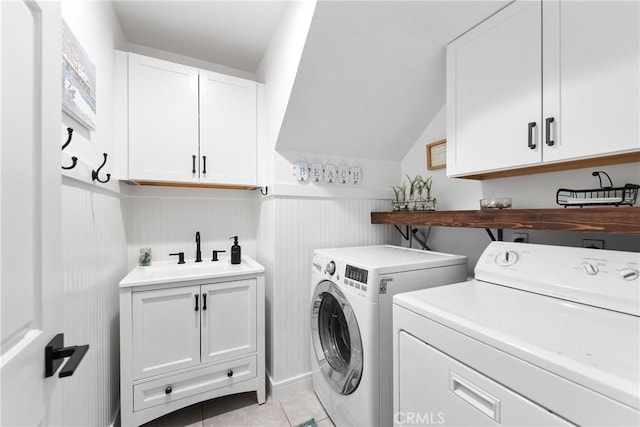 968 Saddlehorn Pl, Newbury Park, CA 91320 - laundry area with washer and dryer, cabinet space, light tile patterned floors, and wainscoting