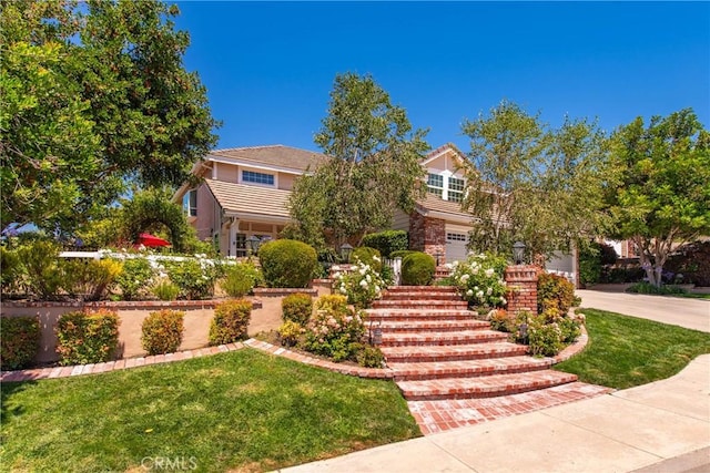 968 Saddlehorn Pl, Newbury Park, CA 91320 - view of property hidden behind natural elements featuring driveway, a front lawn, and an attached garage