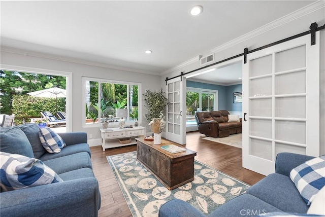 968 Saddlehorn Pl, Newbury Park, CA 91320 - living area with a barn door, wood-type flooring, crown molding, recessed lighting, and french doors