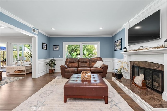 968 Saddlehorn Pl, Newbury Park, CA 91320 - living room with healthy amount of natural light, wood finished floors, wainscoting, a premium fireplace, and recessed lighting