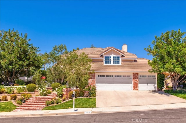 968 Saddlehorn Pl, Newbury Park, CA 91320 - view of front of home with a tiled roof, concrete driveway, and a chimney