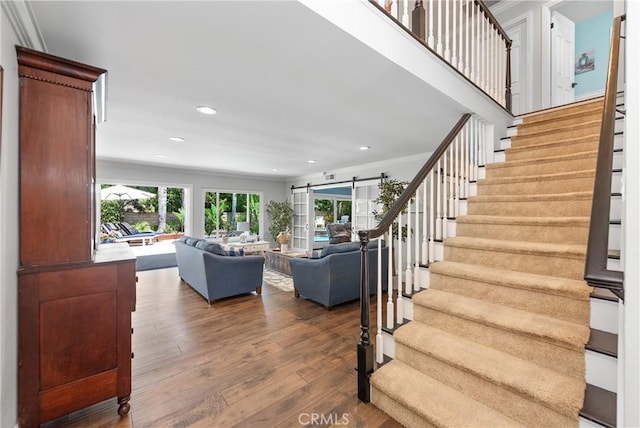 968 Saddlehorn Pl, Newbury Park, CA 91320 - staircase featuring plenty of natural light, a barn door, hardwood / wood-style flooring, ornamental molding, and recessed lighting