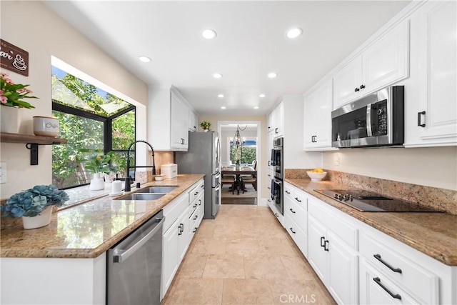 968 Saddlehorn Pl, Newbury Park, CA 91320 - kitchen featuring appliances with stainless steel finishes, recessed lighting, white cabinetry, light stone countertops, and open shelves