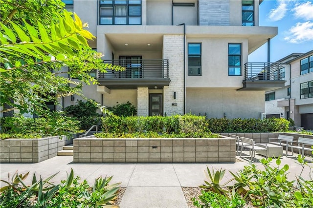 2890 Via Alta Pl, San Diego, CA 92108 - view of front of home with stucco siding, stone siding, and a balcony