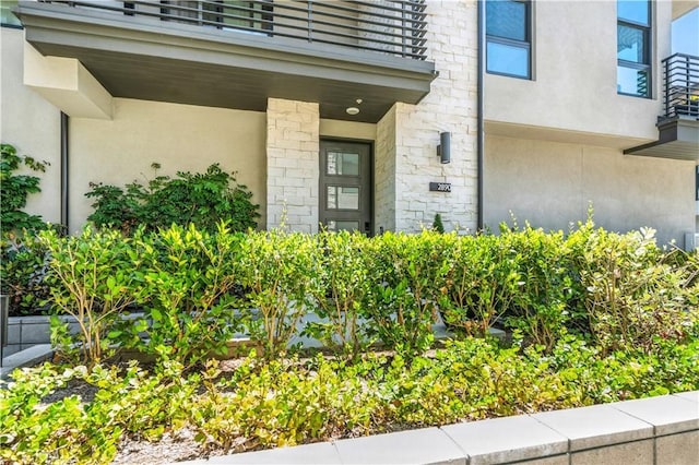 2890 Via Alta Pl, San Diego, CA 92108 - doorway to property featuring stucco siding, stone siding, and a balcony