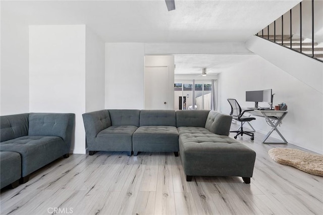 7147 Fulton Way, Stanton, CA 90680 - living room featuring light wood-style floors, ceiling fan, and stairway