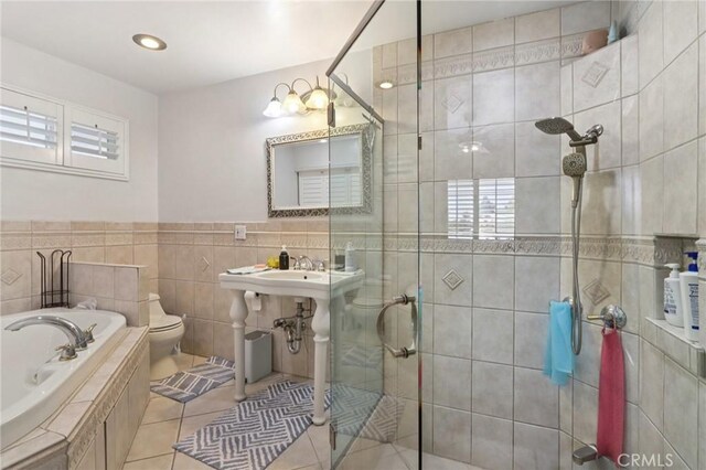 1776 San Bernardino Ave, Pomona, CA 91767 - bathroom with a stall shower, a bath, tile patterned flooring, tile walls, and recessed lighting