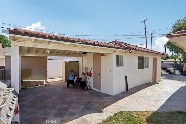 1776 San Bernardino Ave, Pomona, CA 91767 - back of house featuring stucco siding, a patio area, a tiled roof, and a carport