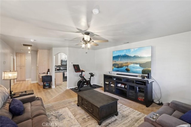 1776 San Bernardino Ave, Pomona, CA 91767 - living room with a ceiling fan, arched walkways, and light wood-type flooring