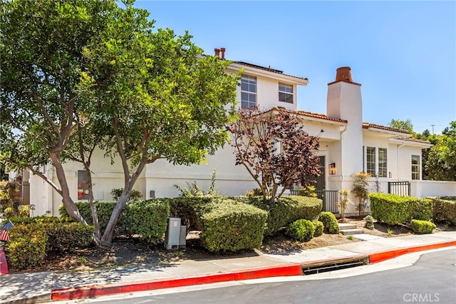 27884 Via De Costa, San Juan Capistrano, CA 92675 - view of front of home with a chimney, stucco siding, and a tile roof
