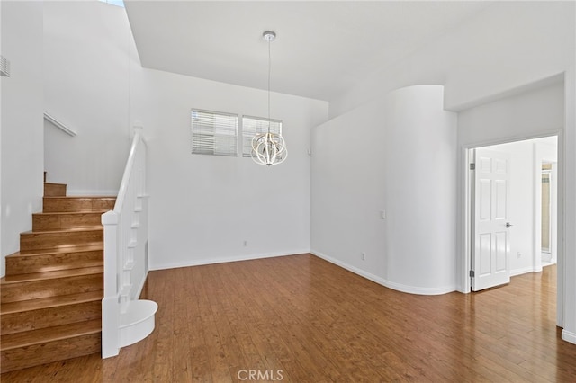 27884 Via De Costa, San Juan Capistrano, CA 92675 - unfurnished living room featuring wood finished floors, stairs, and a chandelier
